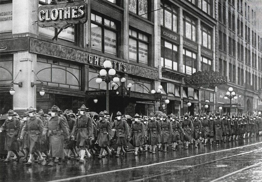 The U.S. Army 39th regiment wear masks to prevent influenza in Seattle in December of 1918. The soldiers are on their way to